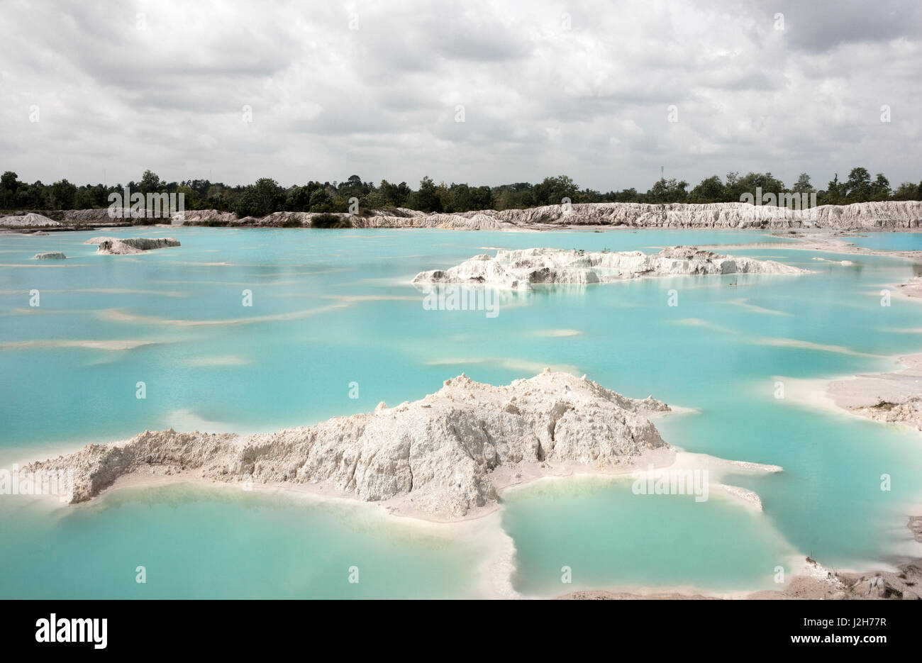 Man-made artificial lake Kaolin, turned from mining ground holes. Due to mining, holes were formed covered by rain water, forming a clear blue lake, A Stock Photo