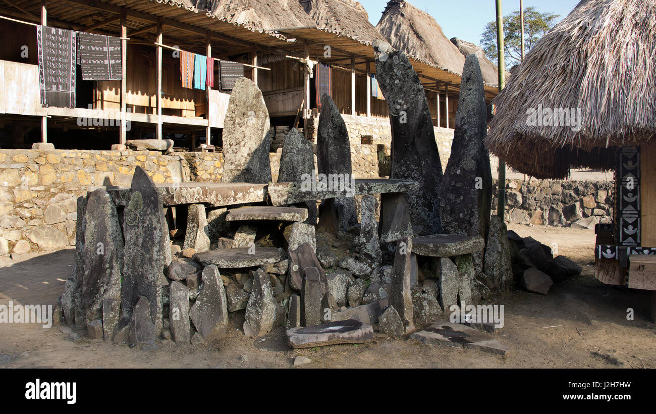 Stone tablets in Bena a traditional village with grass huts of the Ngada people in Flores near Bajawa, Indonesia. Stock Photo