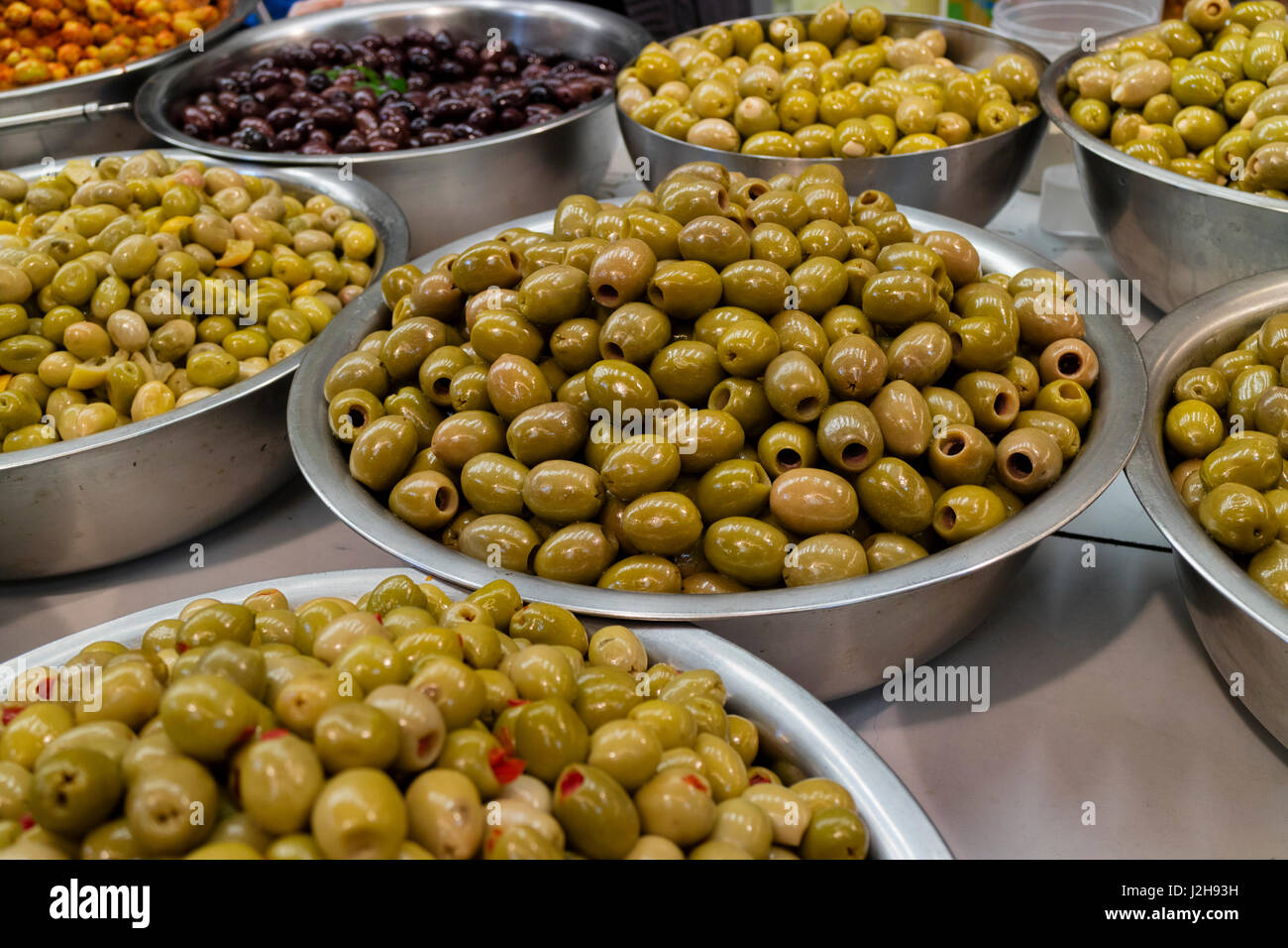 Bowls with different types of olives on the market Stock Photo