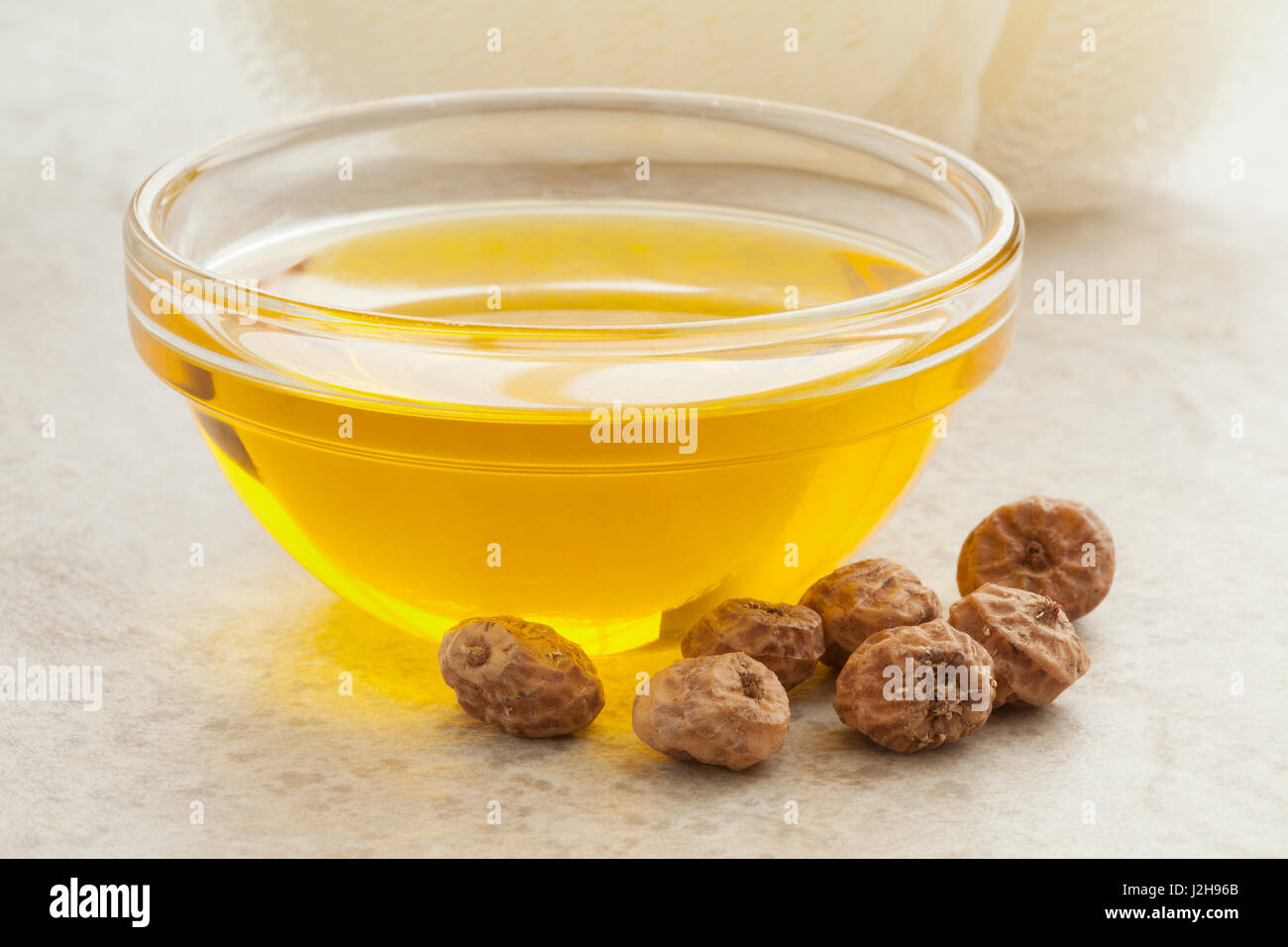 Glass bowl with Chufa oil and nuts Stock Photo