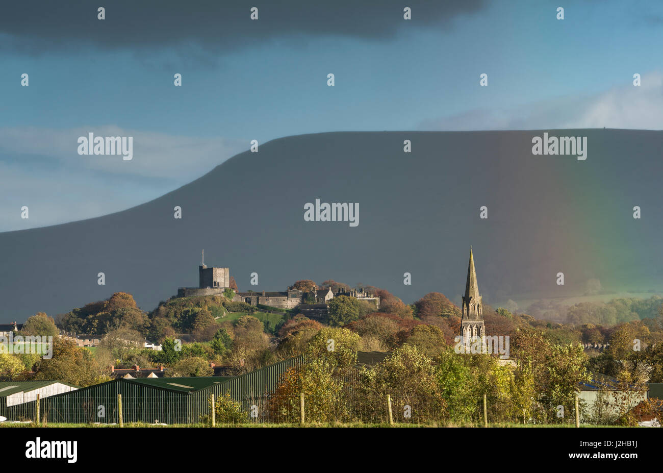 View of Clitheroe Castle in front of Pendle Hill with rainbow
