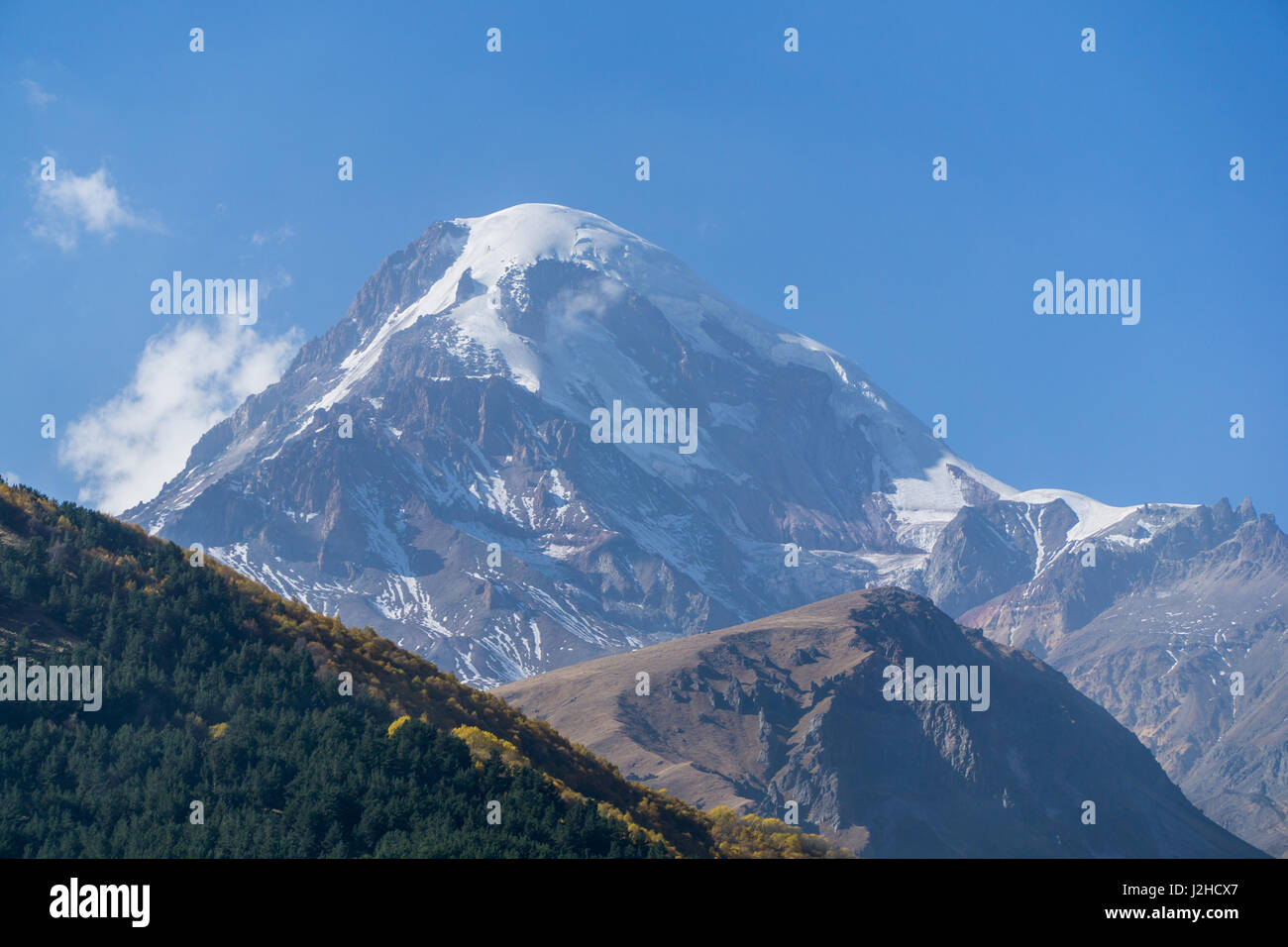 Mount Kazbek, view from Stepantsminda town in Georgia. It is one of the major mountains of the Caucasus. September Stock Photo