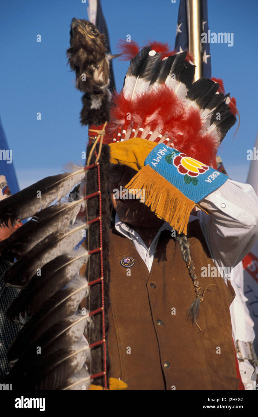 Blackfeet pow wow regalia of an eagle staff, feather headdress and beaded gauntlet gloves Stock Photo
