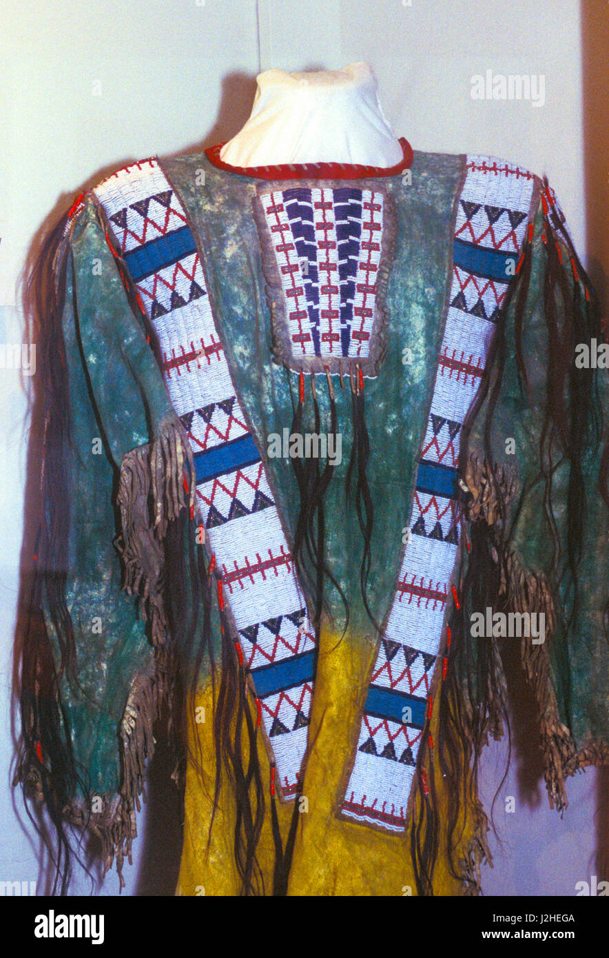 Blackfeet man's painted leather fringed shirt with beaded strips decorating the front yoke and shoulders Stock Photo