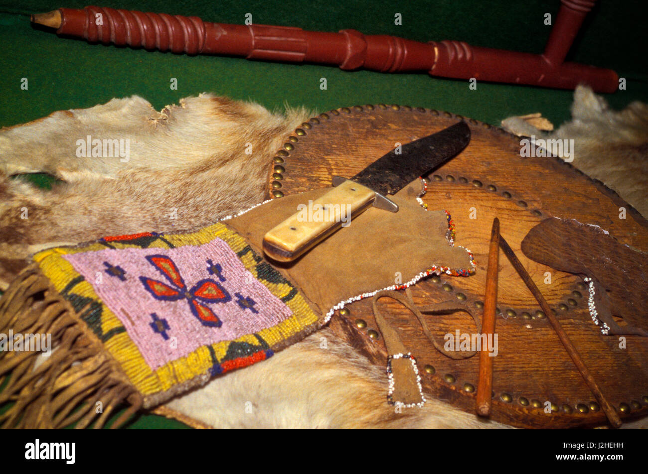 Museum of the Rockies Blackfeet red pipestone pipe and beaded bag with a board used to cut tobacco Stock Photo