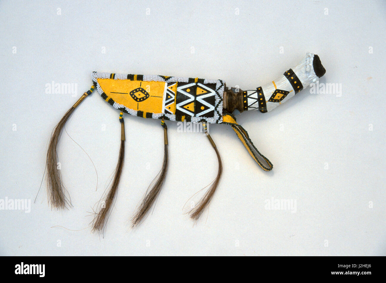 Decorated with paint and beadwork is a contemporary Blackfeet leather sheath with horsehair and a stone knife with a buck horn handle (PR) Stock Photo