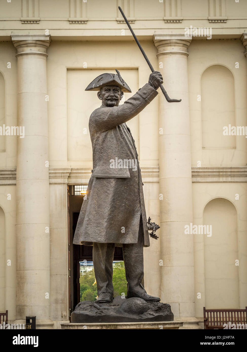 The 'In-Pensioner' bronze statue of a Chelsea pensioner outside the north entrance to the Chelsea Royal Hospital, London, UK Stock Photo