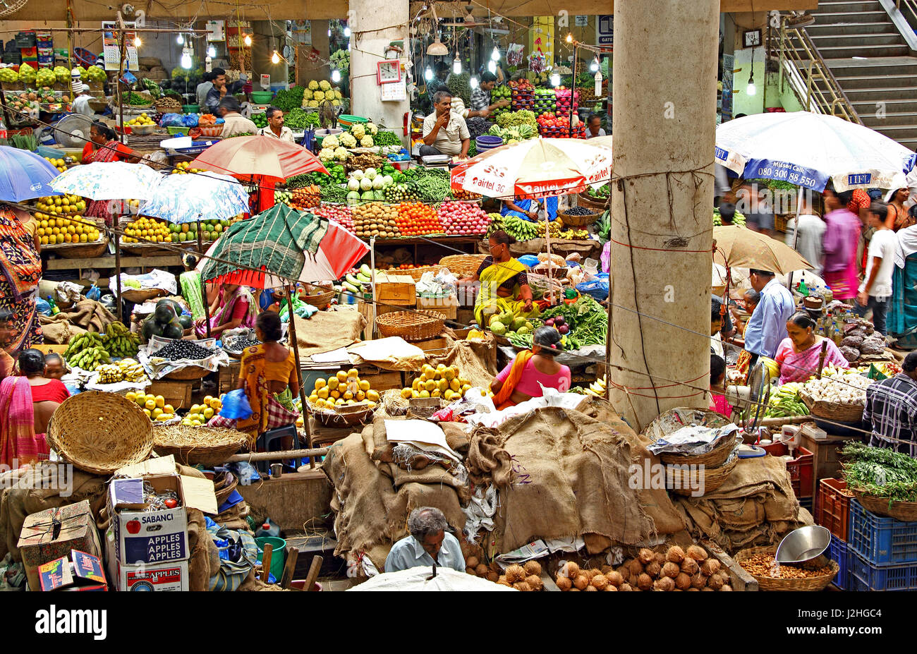 Vendors and customers trade at the daily fruits and vegetable market in Panjim, Goa, India. For editorial use only Stock Photo