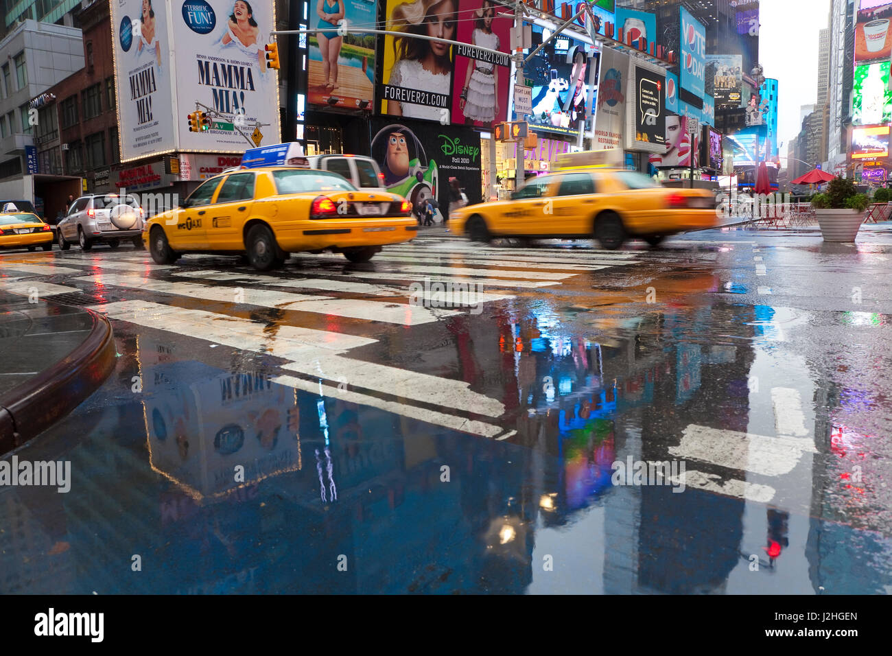 Yellow cabs and reflections in Times Square, New York, USA Stock Photo
