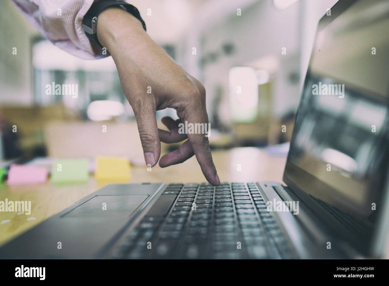 woman finger press button on laptop keyboard Stock Photo - Alamy