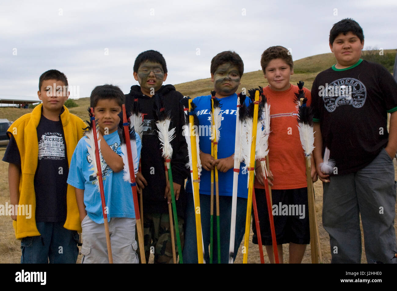 Group of young children members of the Three Affiliated tribes (Mandan, Arikara and Hidatsa) today continue to play many of the traditional games of their ancestors such as the arrow toss game on the Fort Berthold Indian Reservation, North Dakota Stock Photo