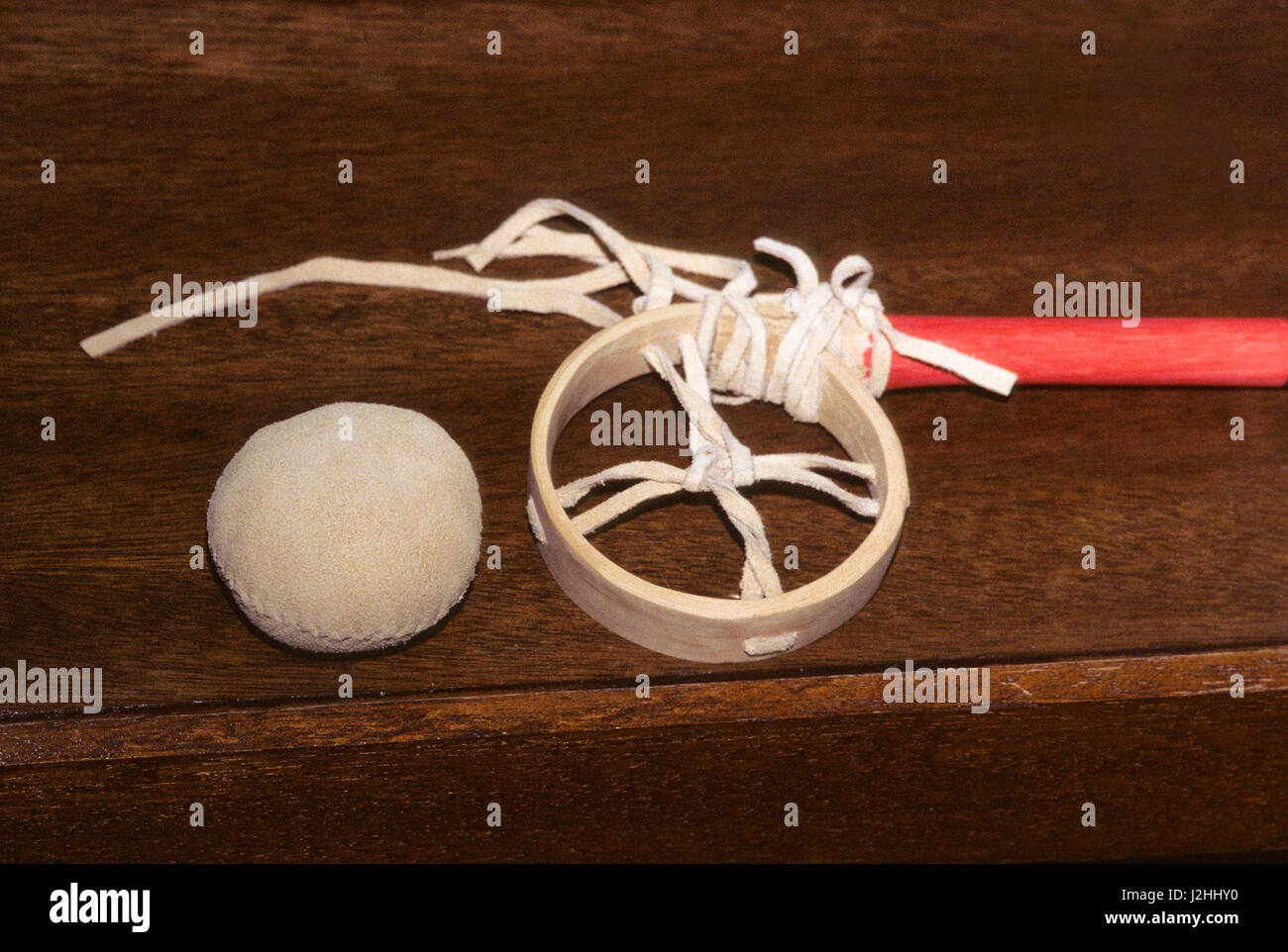 Game stick and leather deer hide ball used in a stick ball game that