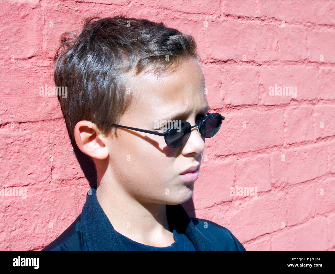 Boy against wall Stock Photo