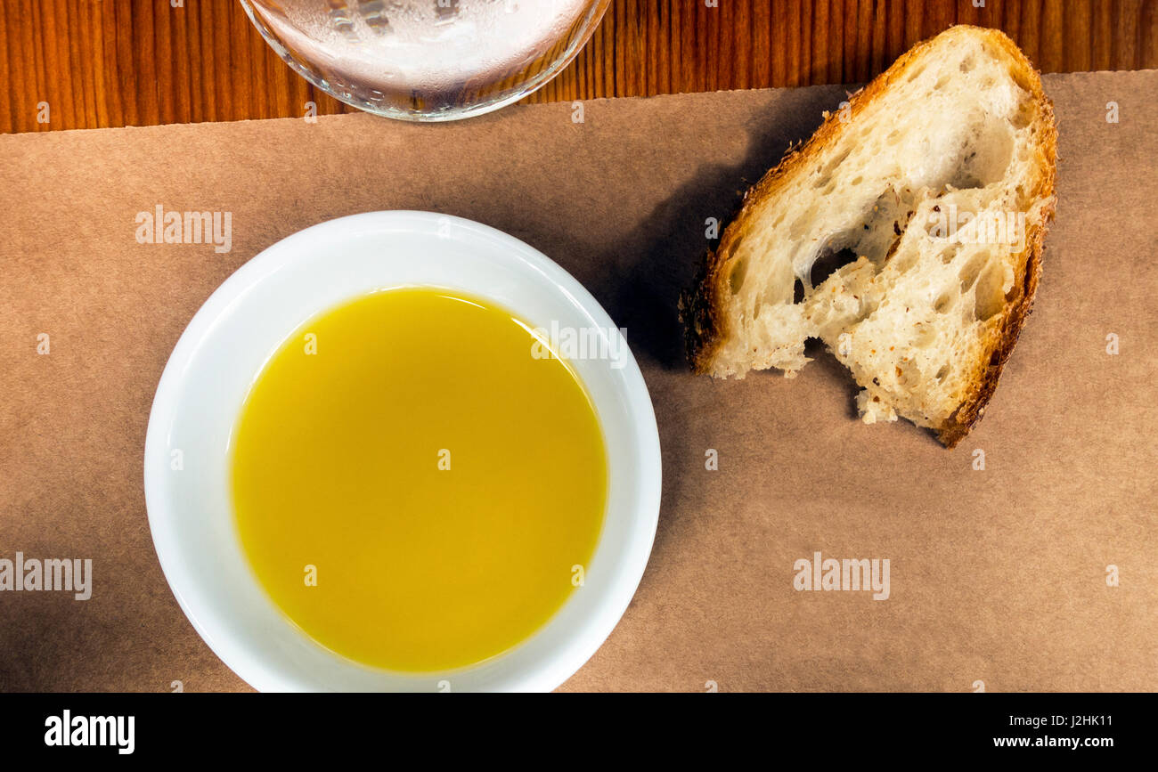 Olive oil in a dipping dish and a slice of rustic Italian bread Stock