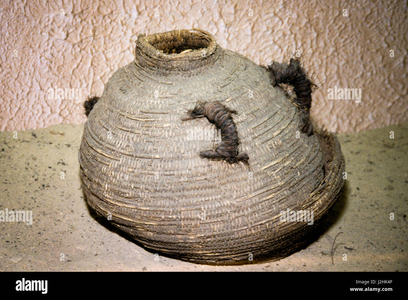Woven basket covered in pine pitch used by the Ute Indians as a water storage jar Stock Photo