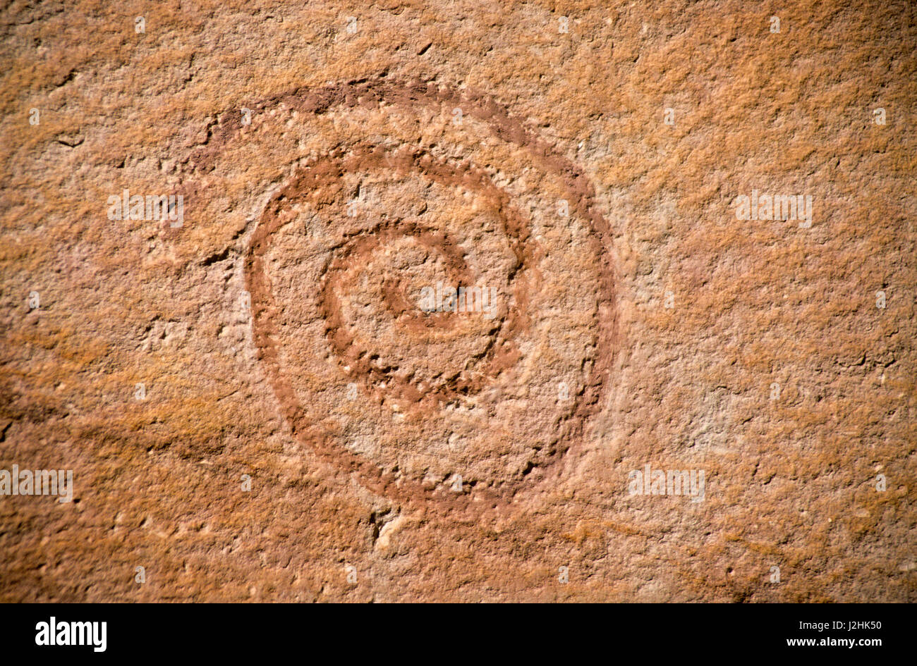 Ute petroglyph rock art with spiral symbol of woman, everlasting or eternity, Vernal Utah Stock Photo