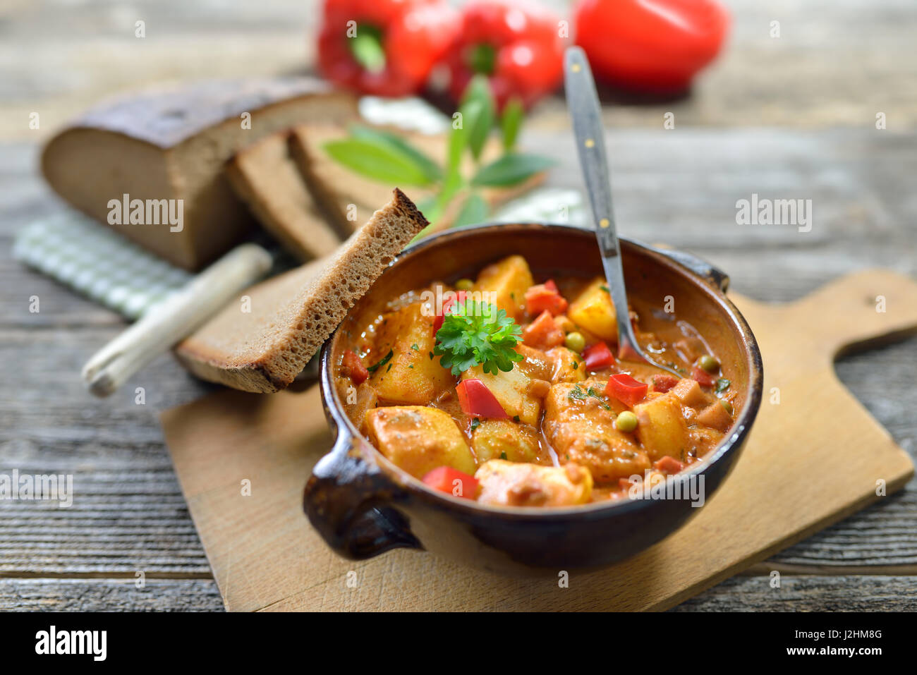Hot vegetarian potato goulash served in a ceramic bowl with delicious