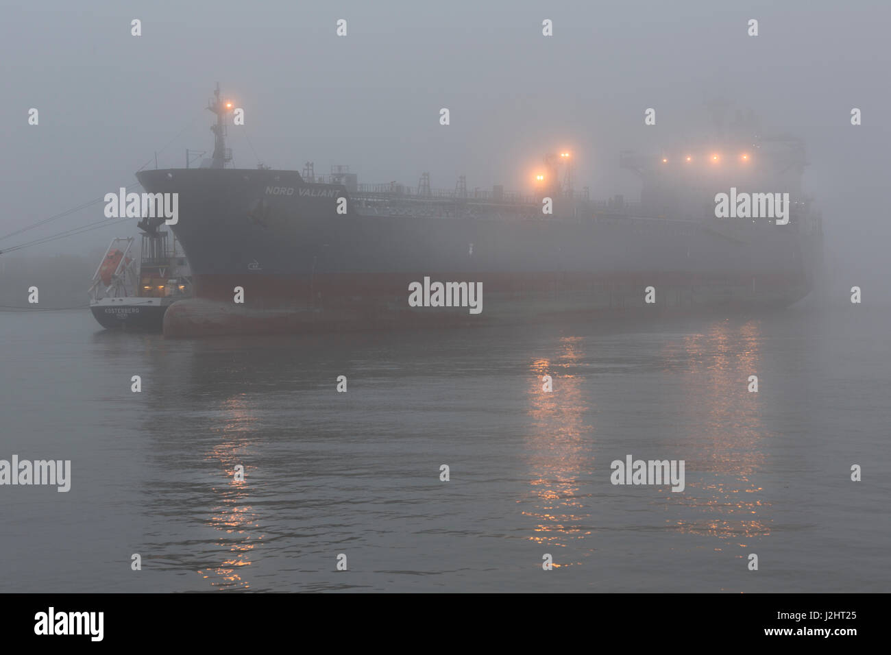 Ship at Hamburg harbor on roadstead Elbe with fog, Hamburg, Germany Stock Photo