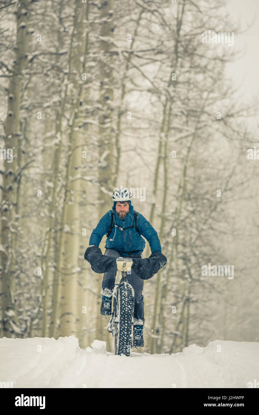 Man riding a fat bike in the snow during the Lone Cone Fat Bike Challenge, Norwood, CO. Stock Photo