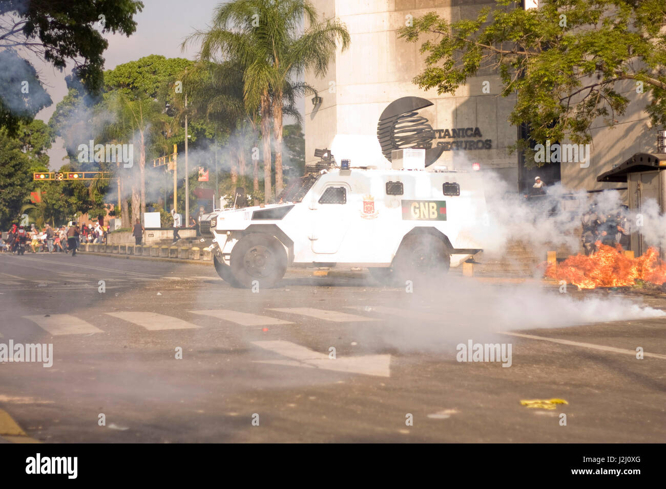 An armor vehicle is attacked with a molotov cocktail during a protest. Stock Photo