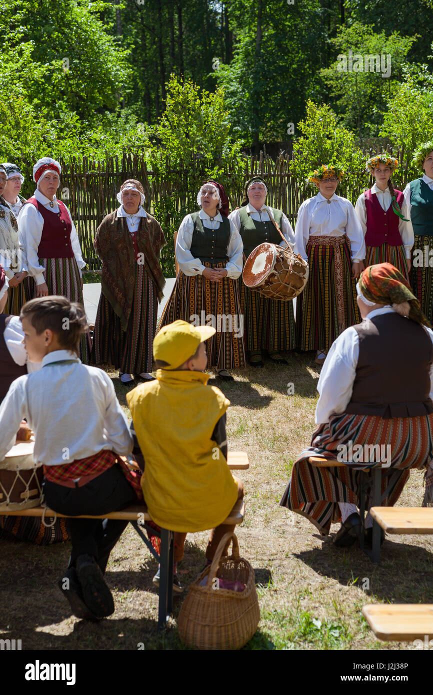 RIGA, LATVIA - 12 JUN 2016: Latvians singing folklore sonds in national costumes. Latvian Ethnographic Museum. Stock Photo