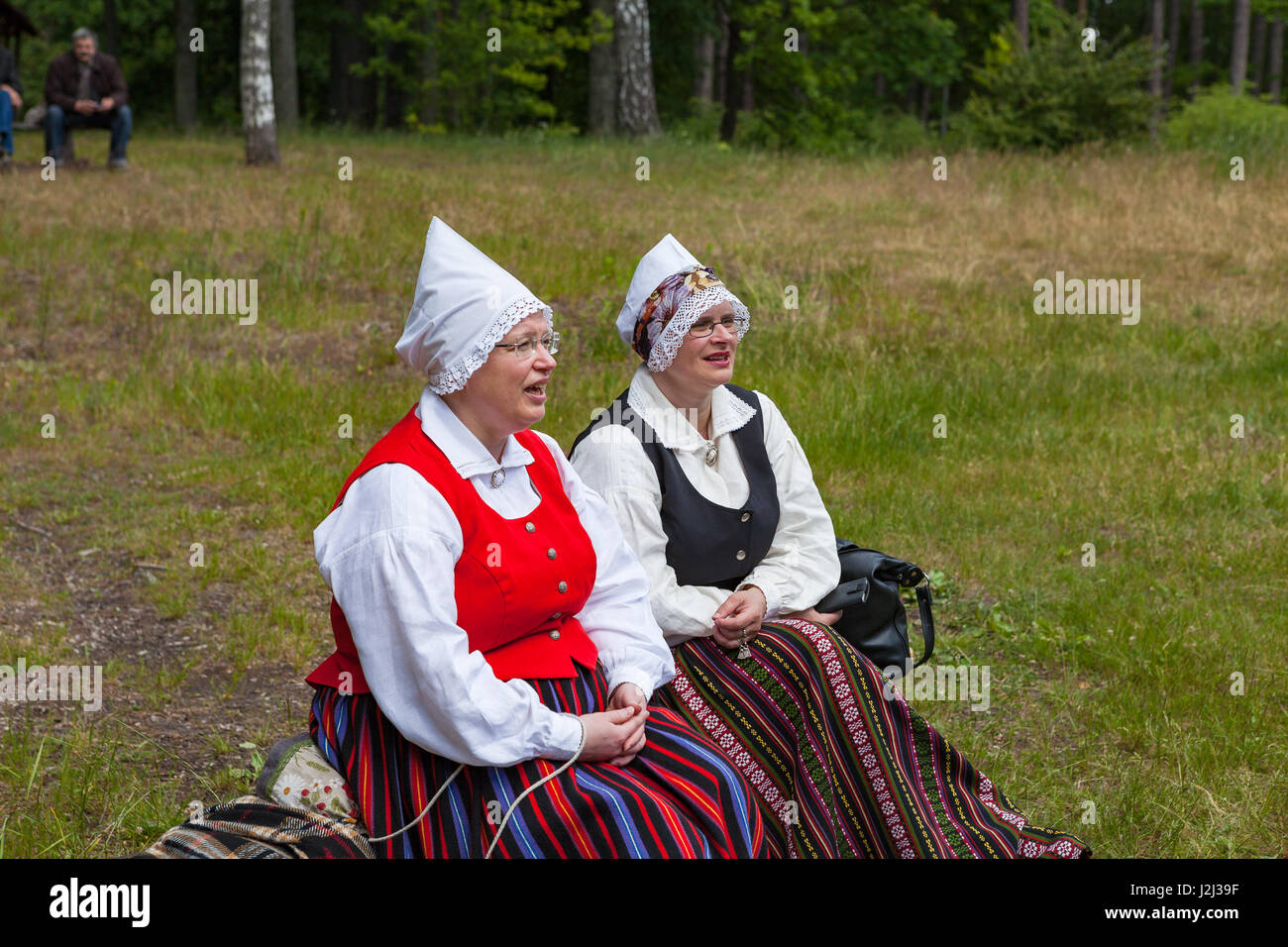 RIGA, LATVIA - 12 JUN 2016: Latvians in the national costumes at the cultucal event. Latvian Ethnographic Museum. Stock Photo