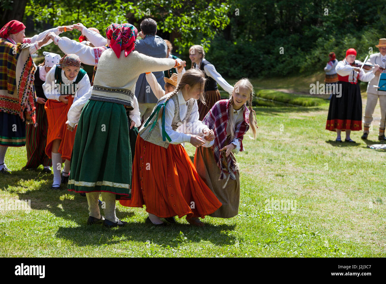 RIGA, LATVIA - 12 JUN 2016: Latvian dancers in national costumes. Cultural event in Latvian Ethnographic Museum. Stock Photo