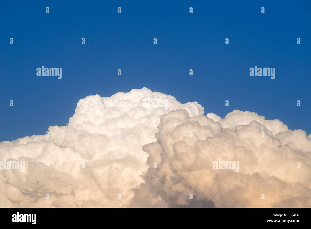 Storm clouds building in the early evening sky at  sunset Stock Photo