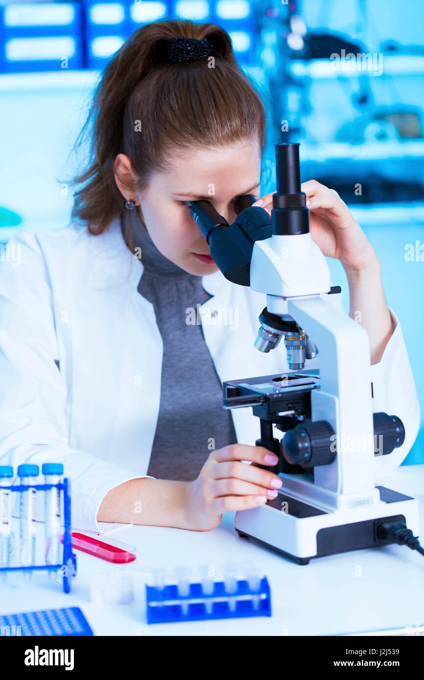 Female scientist using microscope in the laboratory Stock Photo - Alamy