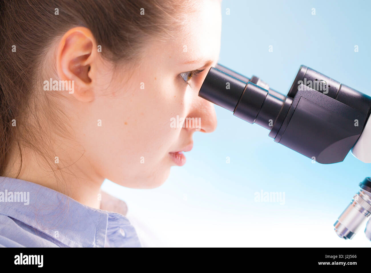 Female scientist using microscope. Stock Photo