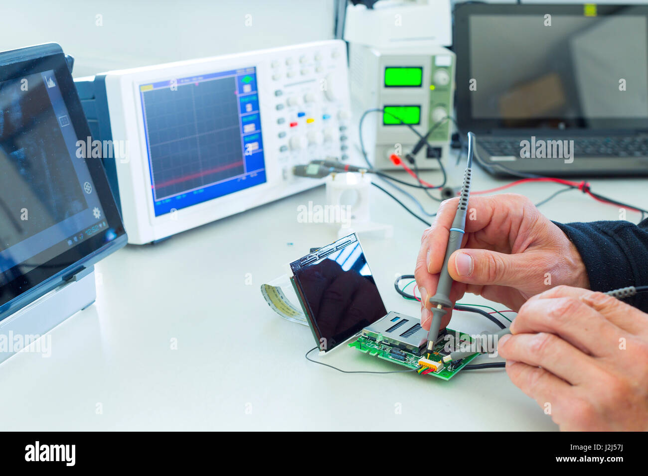 Person soldering in electronics laboratory Stock Photo Alamy