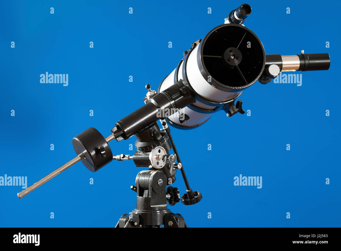 Telescope against blue background. Stock Photo