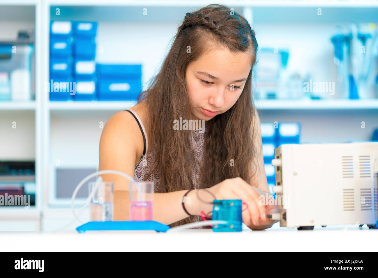 Female science student working with pem proton exchange membrane reversible fuel-cell. Stock Photo