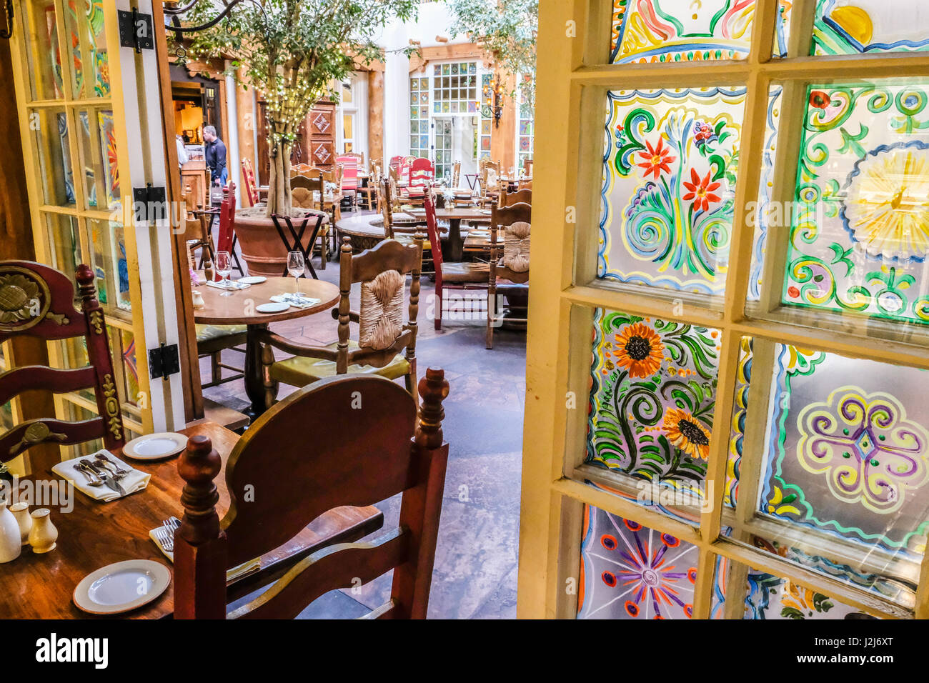 The hand-painted windows of La Plazuela restaurant at the historic La Fonda Hotels Stock Photo