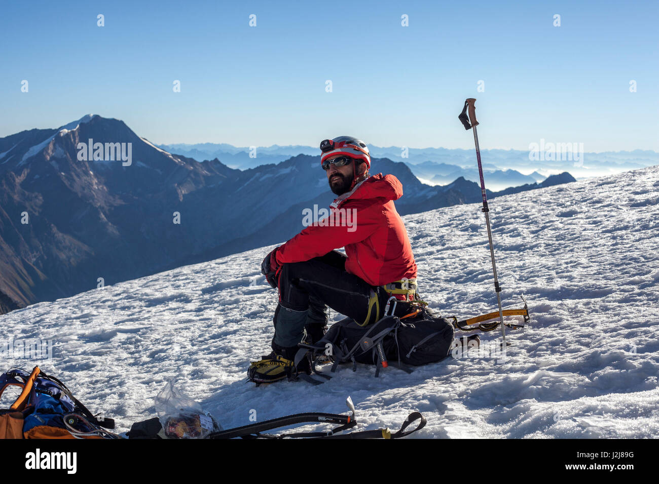 1 person, seated, in front of mountain landscape, glacier, sea of fog, joy, look forward, energy, balanced, destination, success, alone, scenery, Stock Photo