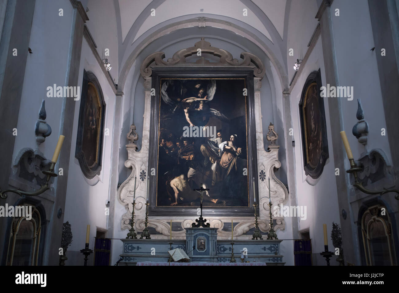 Painting 'The Seven Works of Mercy' by Italian Baroque painter Caravaggio (1606-1607) displayed in the high altar in the church of Pio Monte della Misericordia in Naples, Campania, Italy. Stock Photo