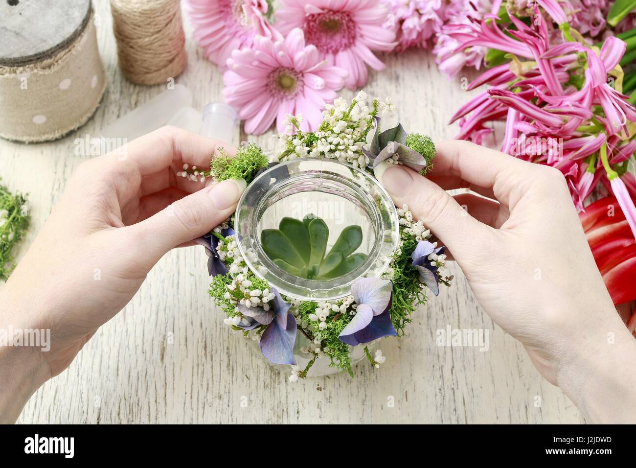 Florist at work: how to make door wreath with white erica plant and hortensia flower. Stock Photo