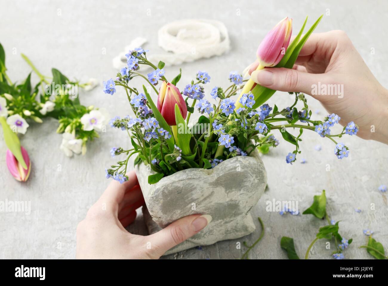 Florist at work How to make floral arrangement inside stone heart vase