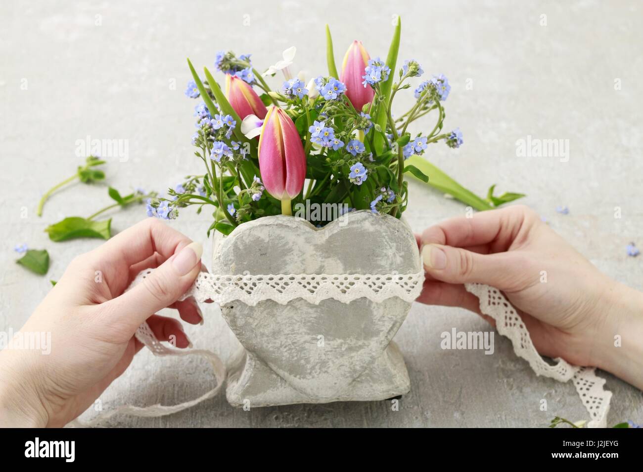 Florist at work How to make floral arrangement inside stone heart vase