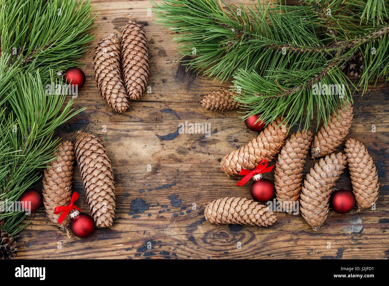 Cones and fir branches on wooden background Stock Photo - Alamy