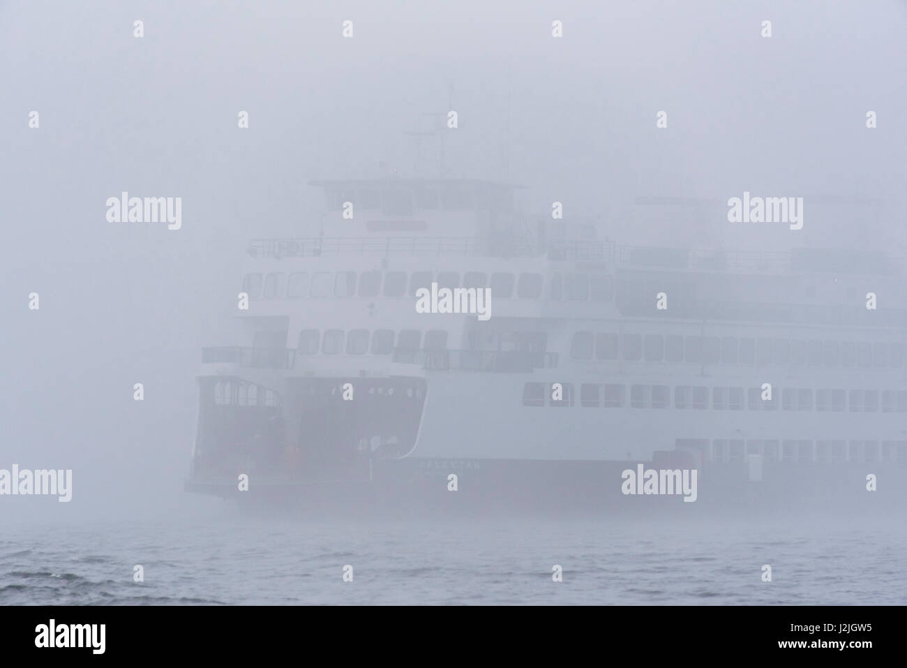 USA, Washington State, Puget Sound. Ferry emerges from dense fog Stock Photo