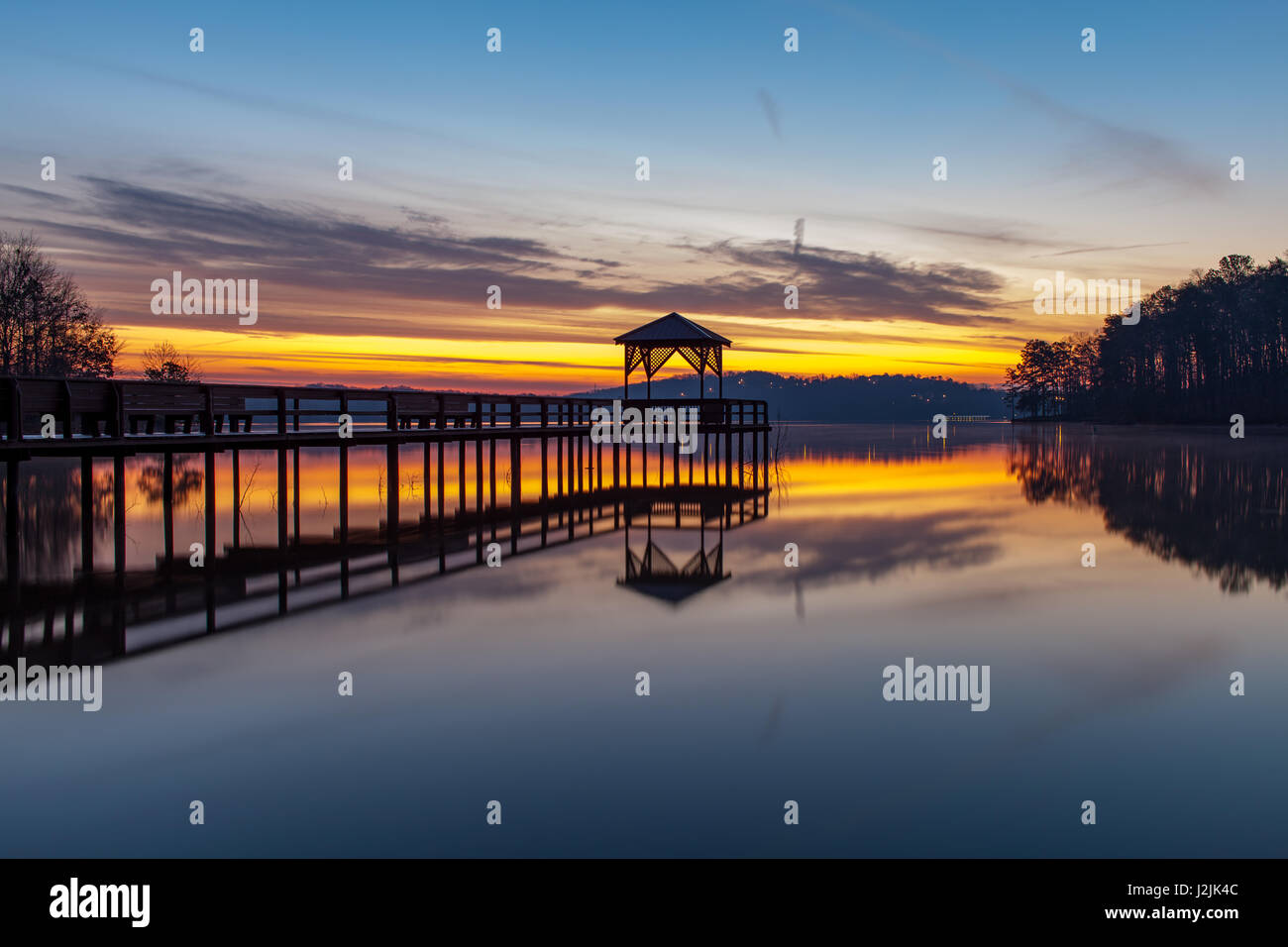 This is an sunrise image taken on the west side of War Hill Park on Lake Lanier.  War Hill Park is a large park on the north end of Lake Lanier in Dawsonville, GA.  It has campsites, beaches, grills, etc. for overnight and day visitors.  From a photographic standpoint it has a few very interesting features and can be effectively shot at either sunrise and sunset for great reflections. Stock Photo