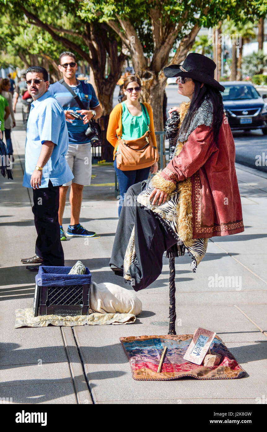 Las Vegas, USA - May 7, 2014: Street performer magician sitting suspended in air holding a cane Stock Photo