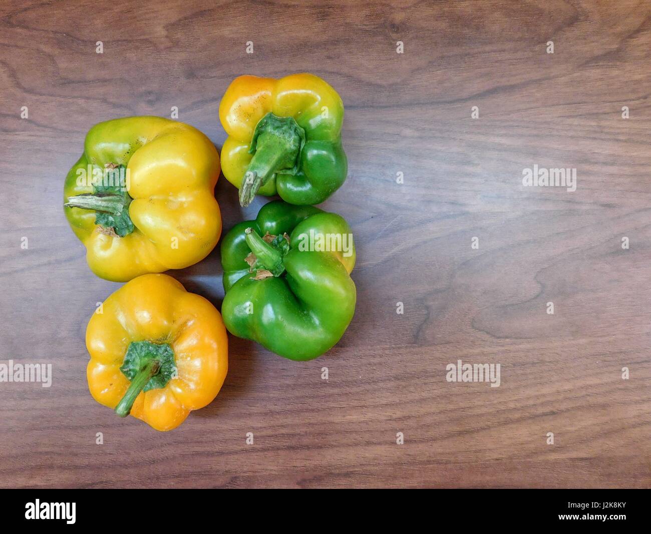 Peppers on wooden background Stock Photo - Alamy