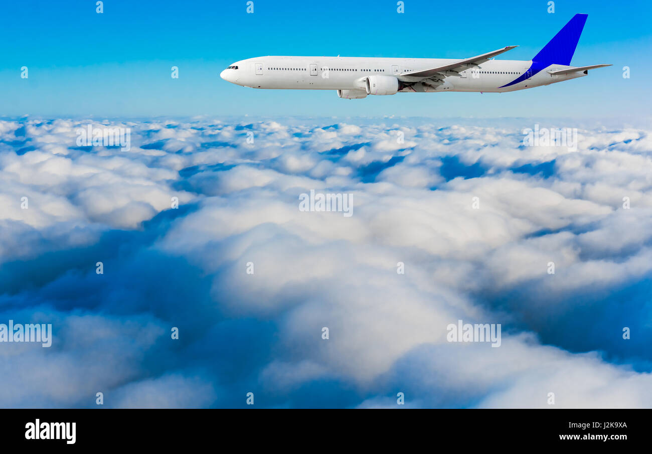 Passenger airplane flying above dramatic clouds Stock Photo - Alamy