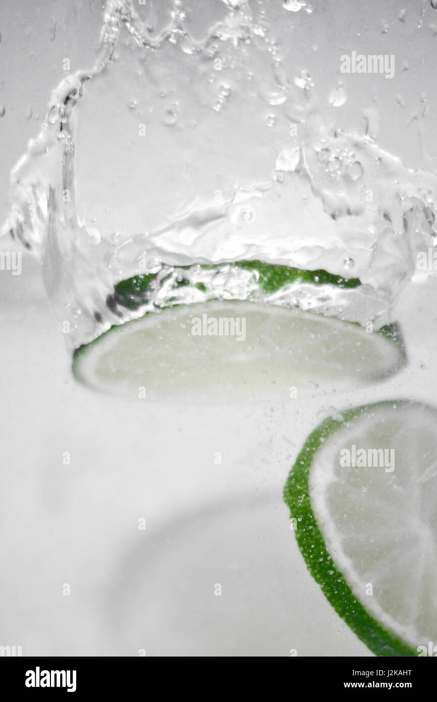 Hey fresh and cool fruits jumping in cold water. Water drops and motion ...