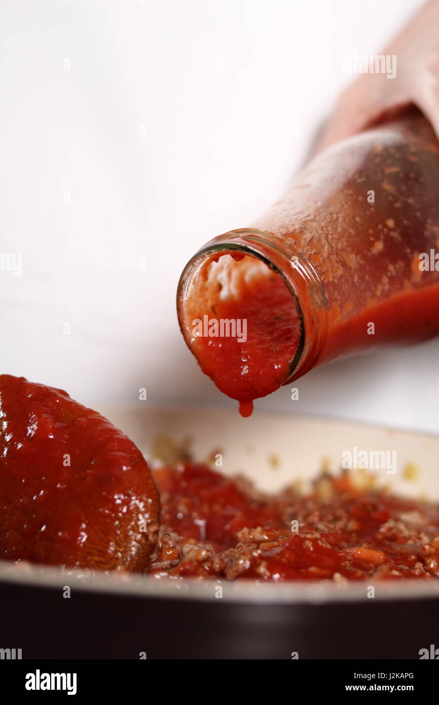 Adding tomato paste into ground meat. Making Lasagna Bolognese Series. Stock Photo