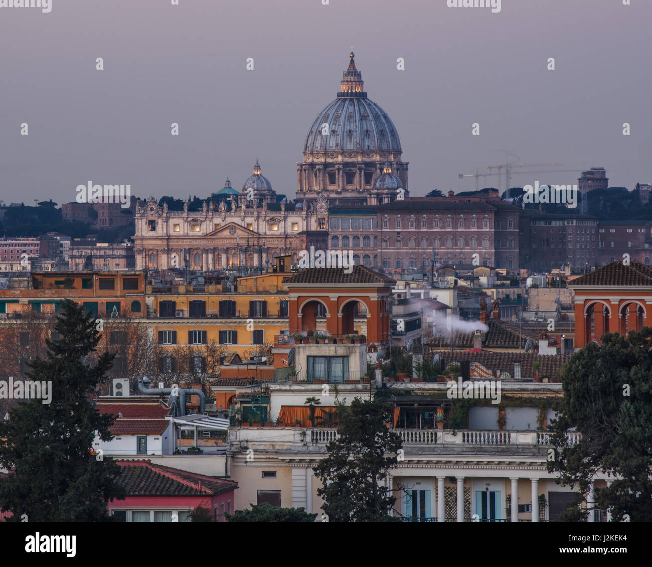 Basilica di San Pietro and Vatican viewed across the rooftops of Rome, Italy, taken from the Piazza del Popolo at dawn Stock Photo