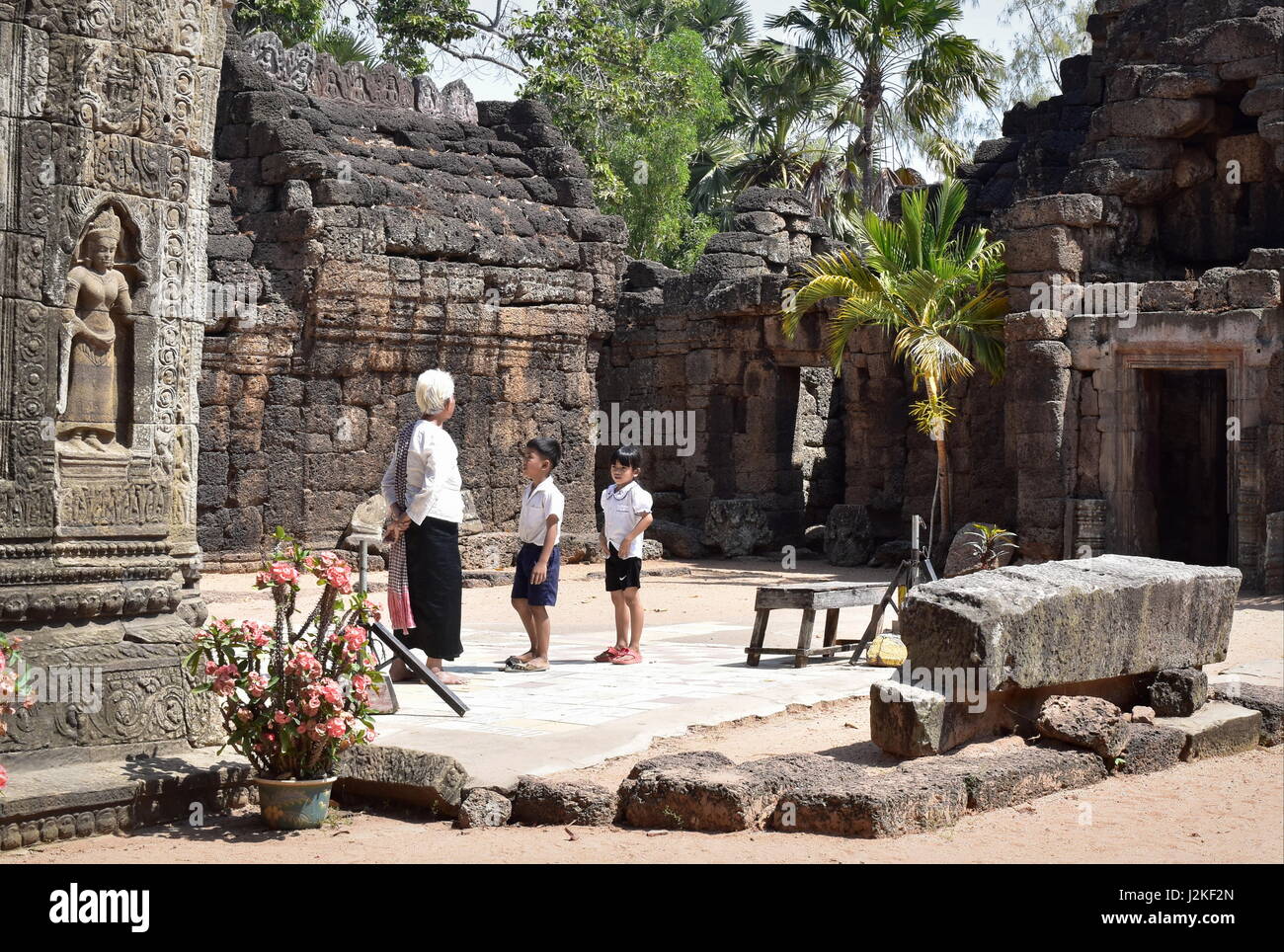 Passing on traditions and cultural heritage from generation to generation, in Prasat Ta Prohm ancient Buddhist temple of Cambodia Stock Photo