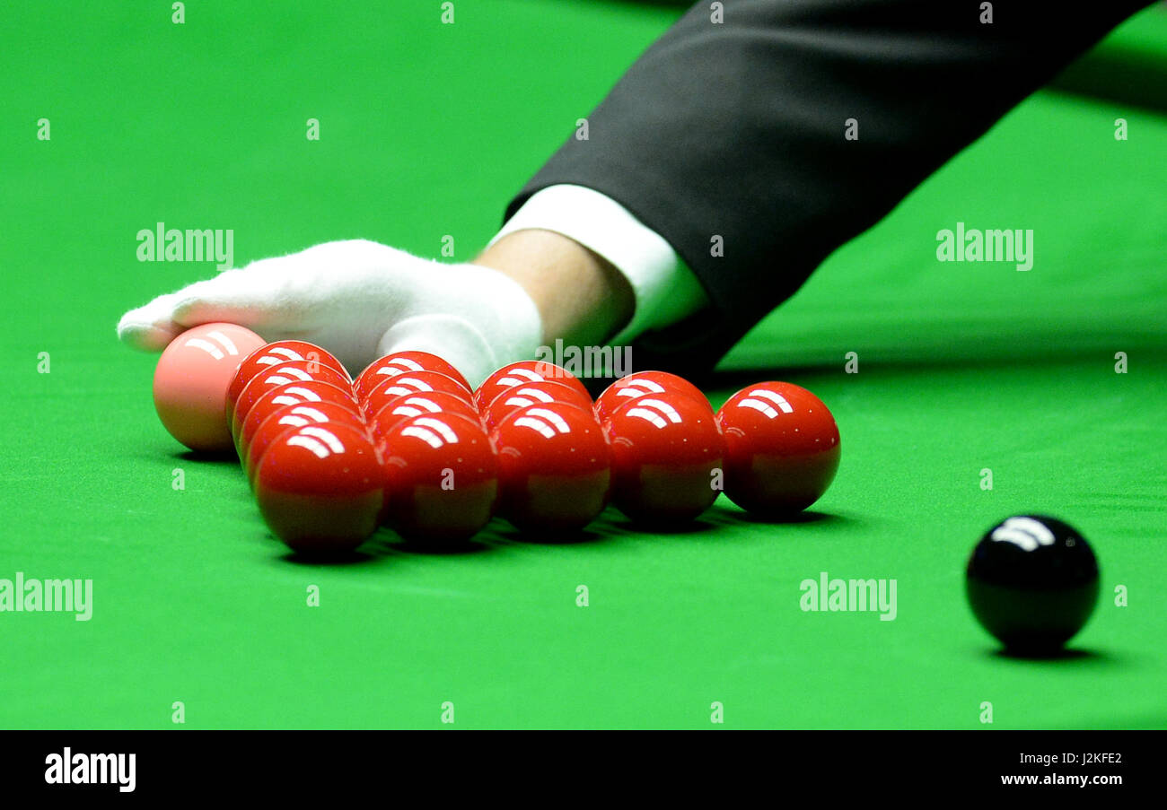 The referee places the pink ball on the spot in the semi final match between John Higgins and